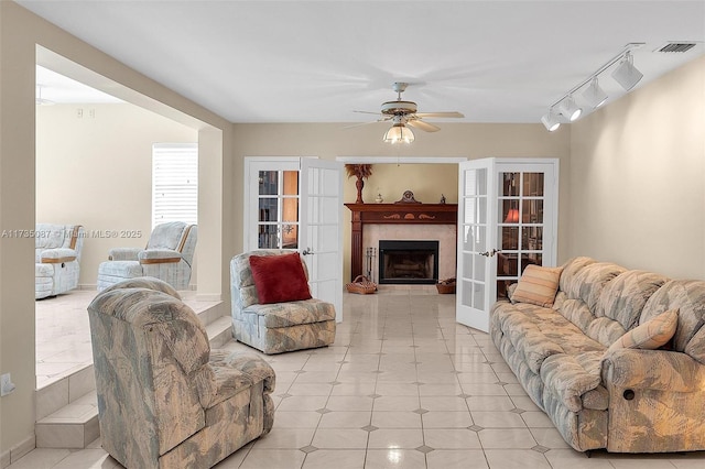 living room featuring french doors, ceiling fan, and rail lighting