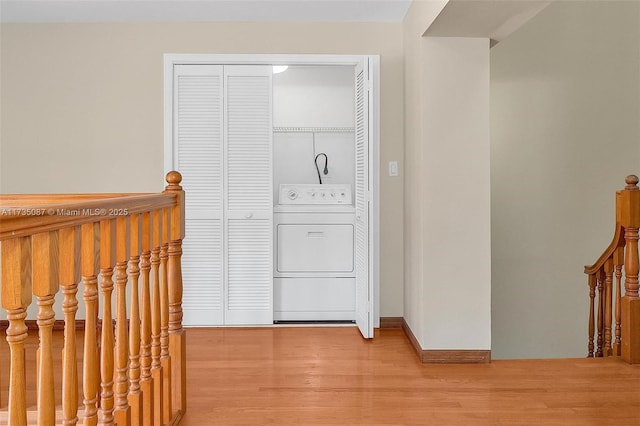 laundry room with washer / clothes dryer and light wood-type flooring