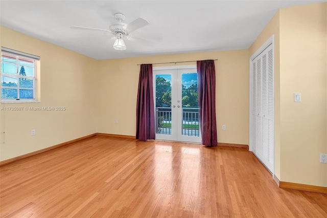 unfurnished room with ceiling fan, light wood-type flooring, and french doors