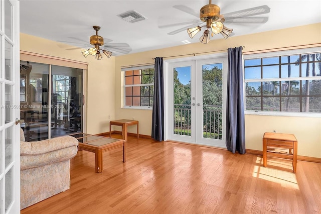 entryway with french doors, ceiling fan, a healthy amount of sunlight, and light hardwood / wood-style flooring