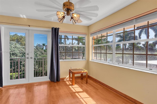 unfurnished sunroom with french doors and ceiling fan