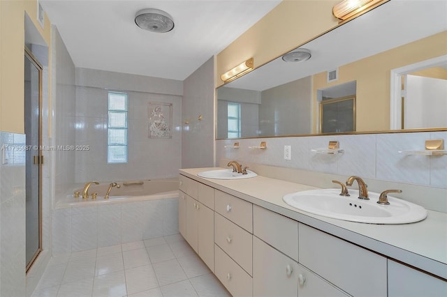 bathroom featuring vanity, separate shower and tub, tile walls, and tile patterned floors