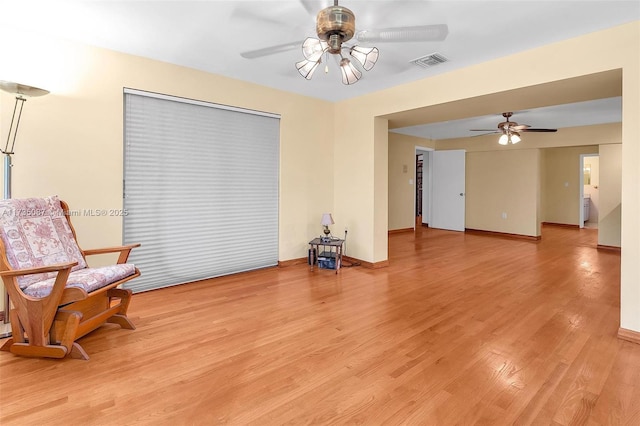 living area with ceiling fan and light hardwood / wood-style floors