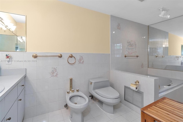 bathroom featuring toilet, tile walls, a bidet, vanity, and tile patterned flooring