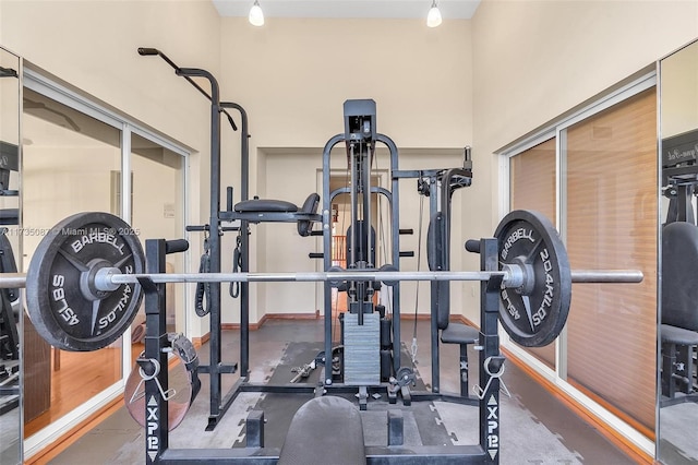 exercise area featuring a towering ceiling