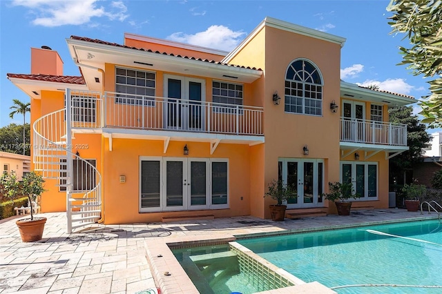 rear view of property with a patio area and french doors