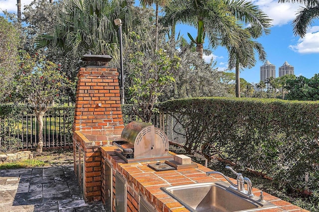 view of patio featuring a grill and sink