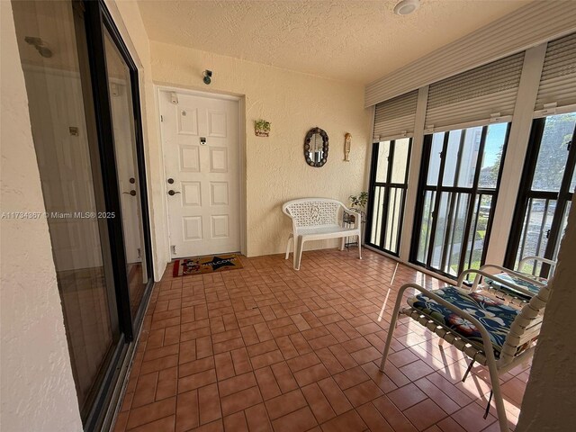 living room with light tile patterned floors and a textured ceiling