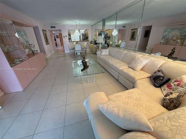 living room featuring a textured ceiling and light tile patterned floors