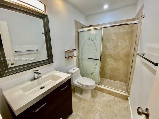 bathroom with vanity, tile patterned floors, toilet, and walk in shower