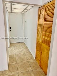 corridor with light tile patterned floors