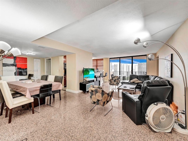 living room with expansive windows and a textured ceiling