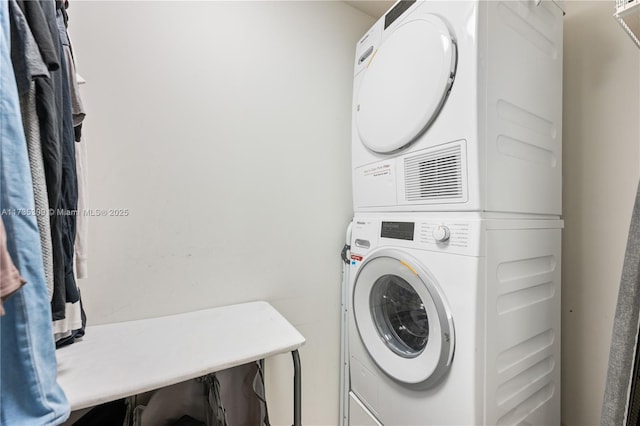 laundry area featuring stacked washer and clothes dryer