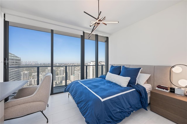 bedroom featuring expansive windows and ceiling fan