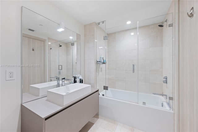 bathroom featuring vanity and combined bath / shower with glass door