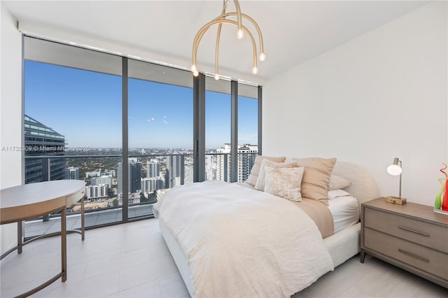 bedroom with access to outside and a wall of windows