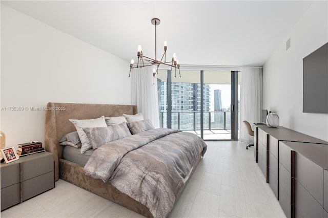 bedroom with a notable chandelier, floor to ceiling windows, and access to exterior