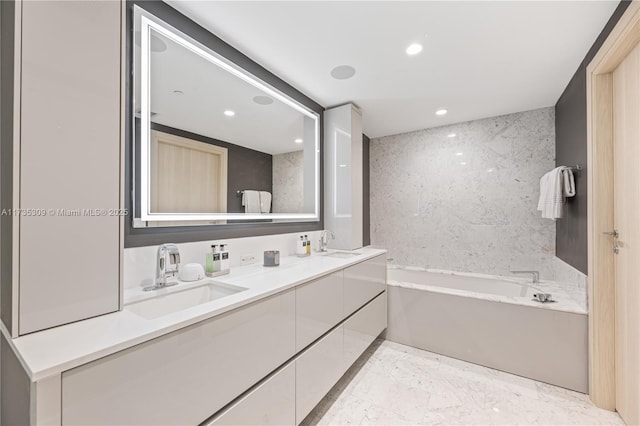 bathroom with vanity and a tub to relax in