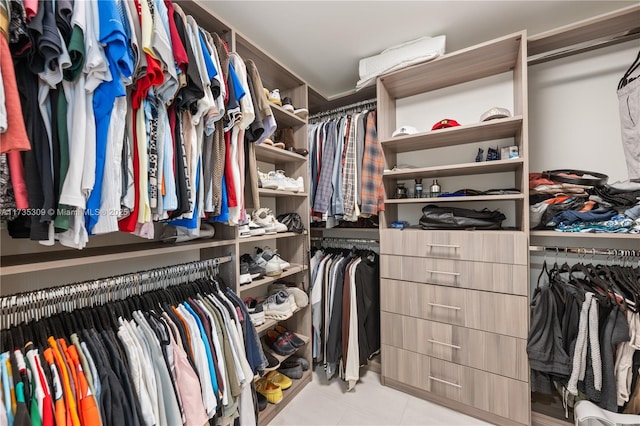 walk in closet featuring light tile patterned flooring