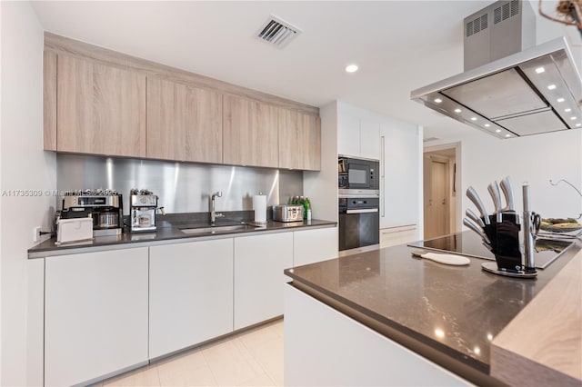 kitchen with white cabinets, island range hood, sink, and black appliances