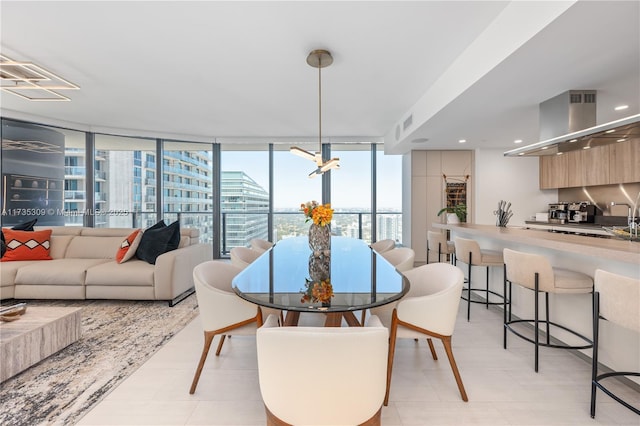 dining area featuring expansive windows and sink