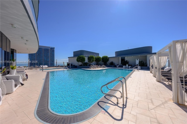 view of swimming pool with a patio