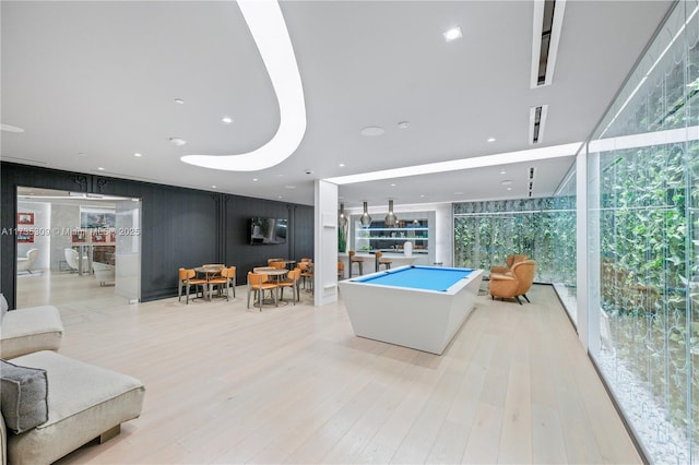 interior space with pool table, a wall of windows, and light wood-type flooring