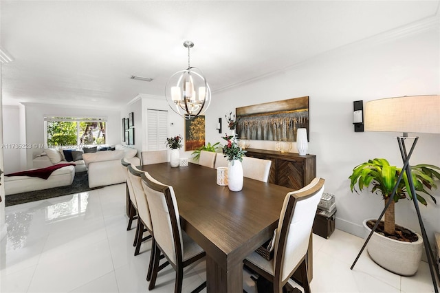 tiled dining room with ornamental molding and a chandelier