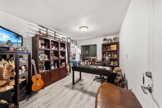 office featuring light hardwood / wood-style flooring and a textured ceiling