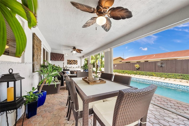 view of patio / terrace featuring an outdoor living space, a fenced in pool, and ceiling fan