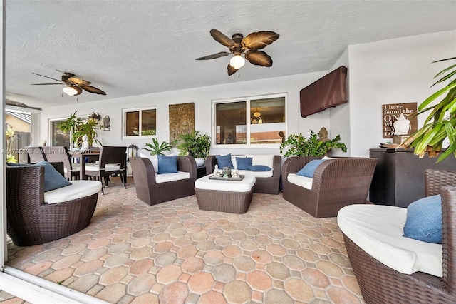 view of patio with an outdoor living space and ceiling fan