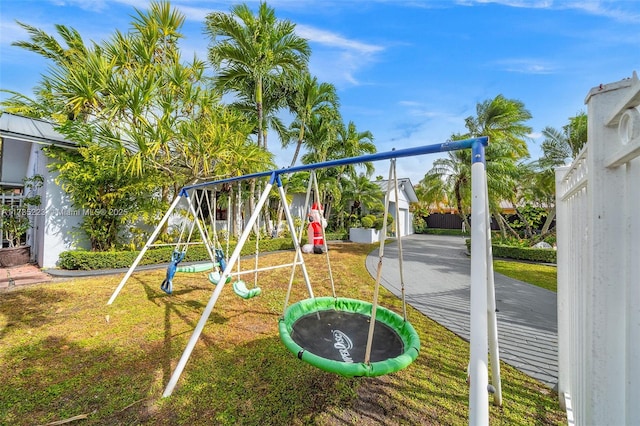 view of playground featuring a trampoline and a yard