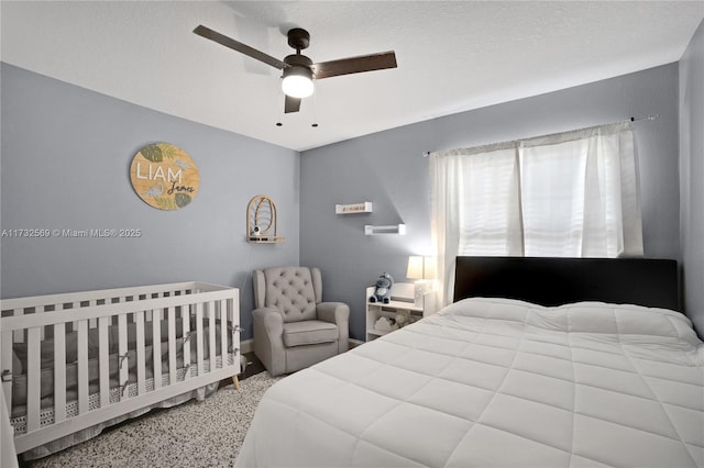 bedroom featuring ceiling fan and a textured ceiling