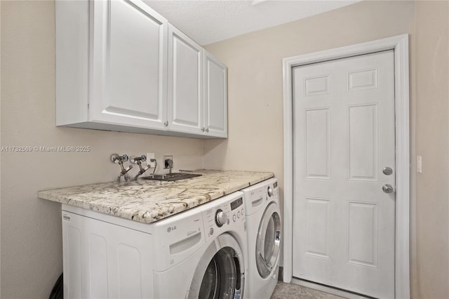 laundry room featuring cabinets and washer and dryer