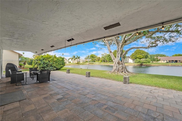 view of patio with a water view