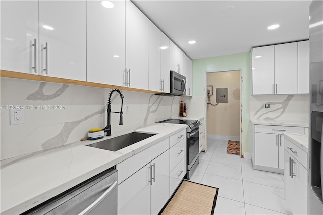 kitchen with white cabinetry, sink, decorative backsplash, and appliances with stainless steel finishes