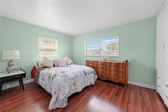 bedroom with dark hardwood / wood-style floors