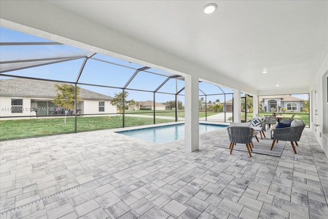 view of pool featuring a lawn, a patio, and glass enclosure