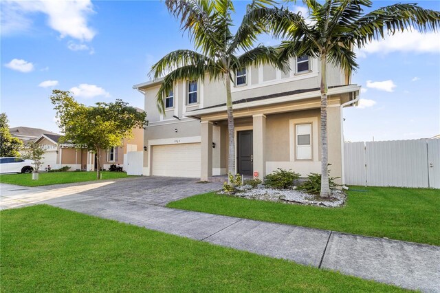 view of front of house featuring a garage and a front lawn