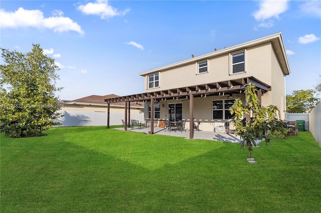 back of property with a yard and a patio