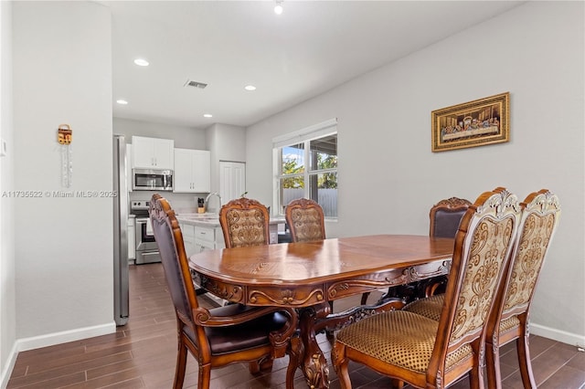 dining area featuring dark hardwood / wood-style flooring and sink