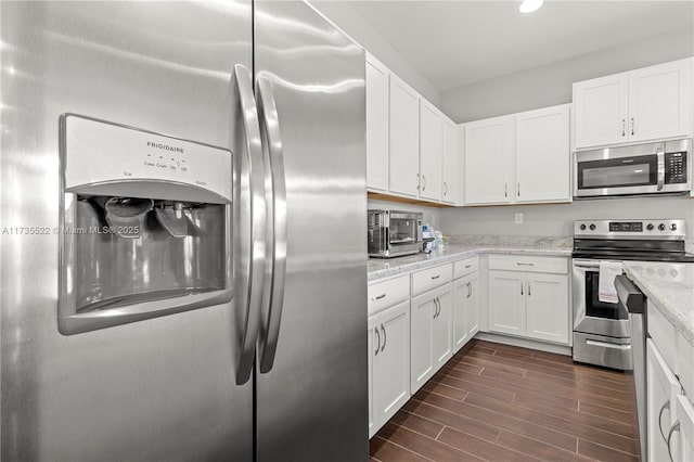 kitchen featuring white cabinetry, appliances with stainless steel finishes, and light stone countertops