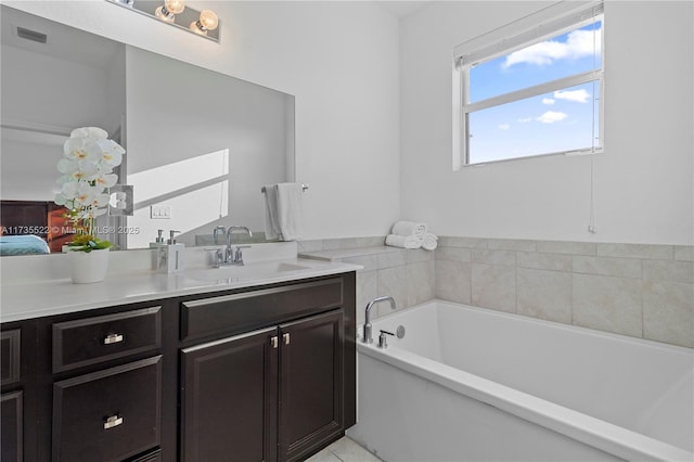 bathroom featuring vanity and a bath