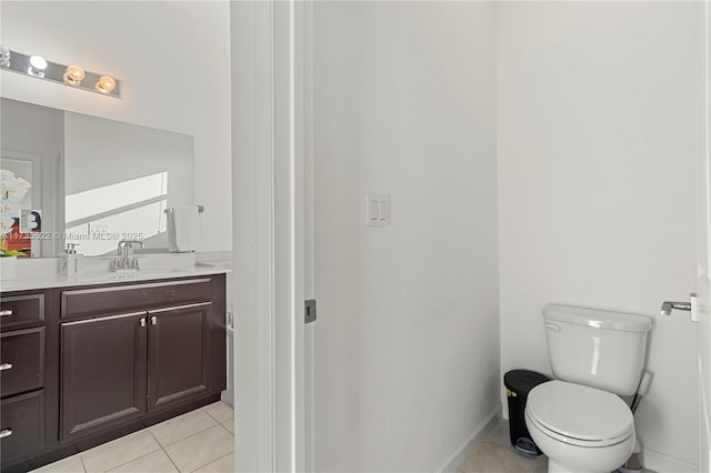 bathroom featuring vanity, tile patterned floors, and toilet