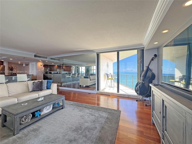 5420 N Ocean Dr Unit 1106, Singer Island, FL 33404 - living room featuring crown molding, wood finished floors, a textured ceiling, and recessed lighting