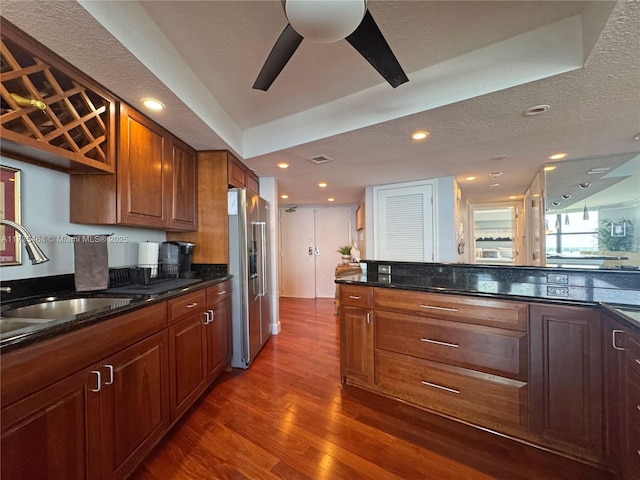 kitchen with high end refrigerator, a sink, dark wood finished floors, recessed lighting, and ceiling fan