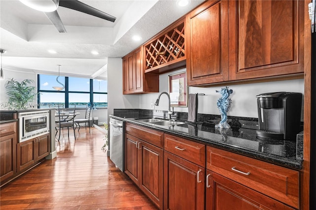 5420 N Ocean Dr Unit 1106, Singer Island, FL 33404 - kitchen with dark wood-style flooring, stainless steel appliances, dark stone counters, recessed lighting, and brown cabinetry