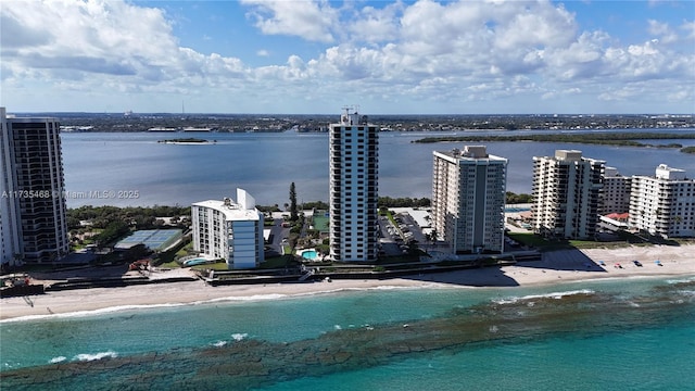 birds eye view of property featuring a water view, a view of city, and a view of the beach