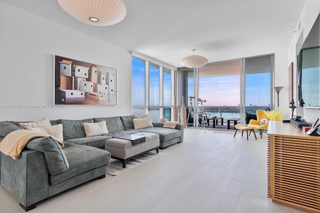 living area with a wall of windows and light wood-style floors