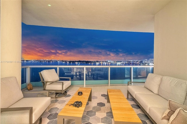 balcony at dusk featuring an outdoor hangout area